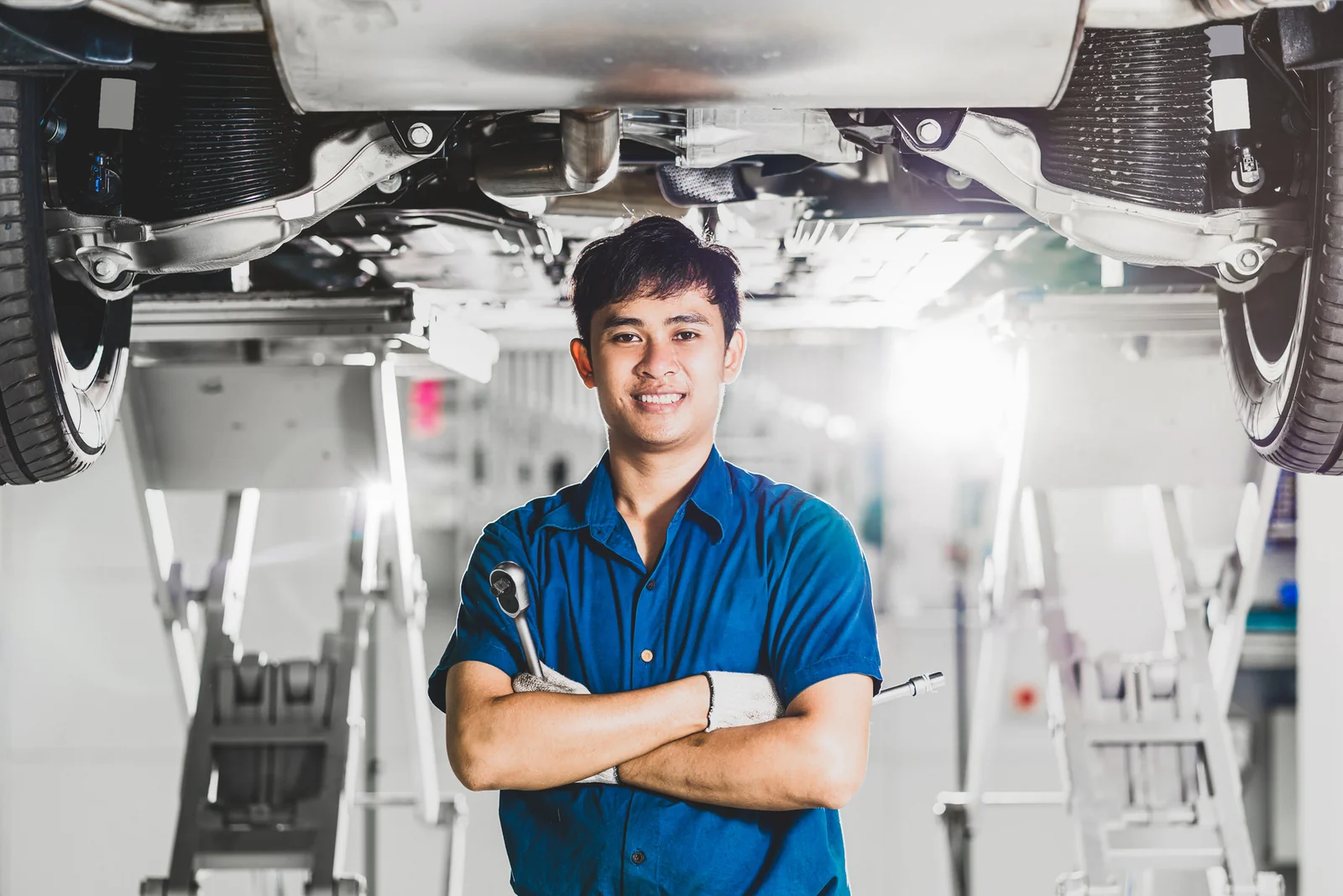 Mechanical workshop engineer standing beside industrial equipment
